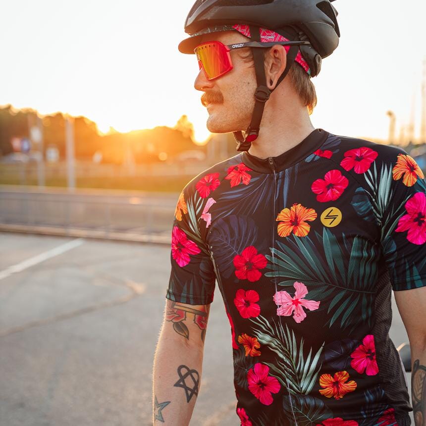 a man wearing a floral cycling jerseys and a helmet